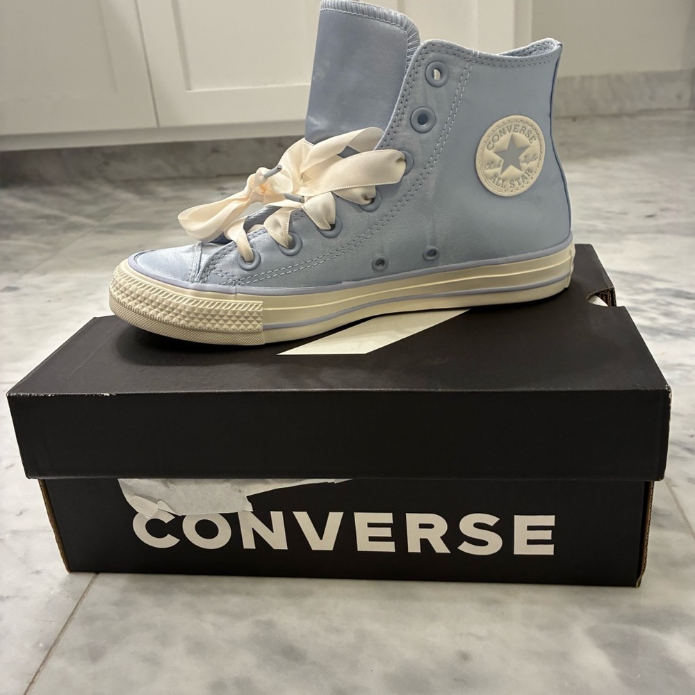 Converse Chuck Taylor All Star New high sneakers with a satin soft blue fabric.